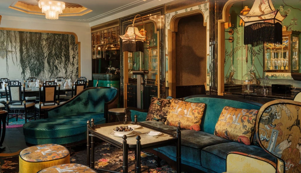 Opulent hotel suite blending colonial French and Vietnamese decor with marble bathrooms, gilded mirrors and opera-themed artwork