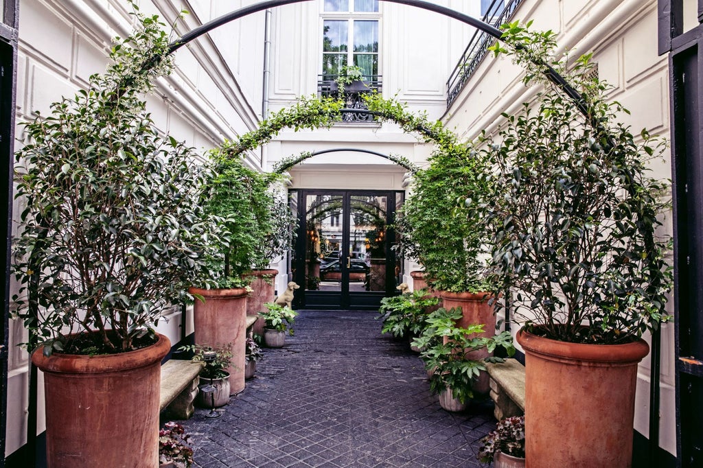 Elegant Parisian hotel facade with ornate balconies, large windows, and classic limestone exterior on a charming boulevard in the heart of France