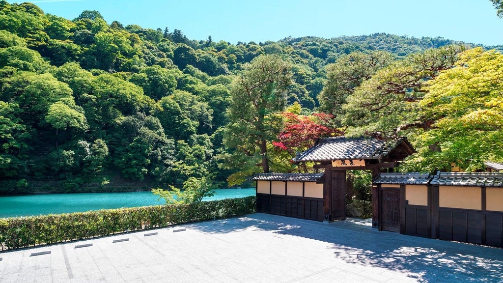 Elegant traditional Japanese ryokan-style luxury hotel nestled by tranquil Kyoto river, featuring wooden architecture and lush garden with soft evening lighting