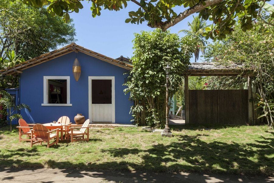 Rustic-chic wooden interior of UXUA Casa Das Artes, featuring handcrafted furniture, warm lighting, and traditional Brazilian design elements in Trancoso.