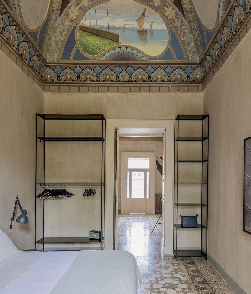 Opulent royal junior suite with high ceilings, antique frescoes, elegant white furnishings, and soft natural light in a historic Italian palazzo