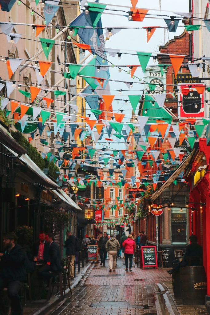 Elegant walking tour of Dublin's historic streets, featuring a professional local guide leading tourists through cobblestone paths with iconic Georgian architecture