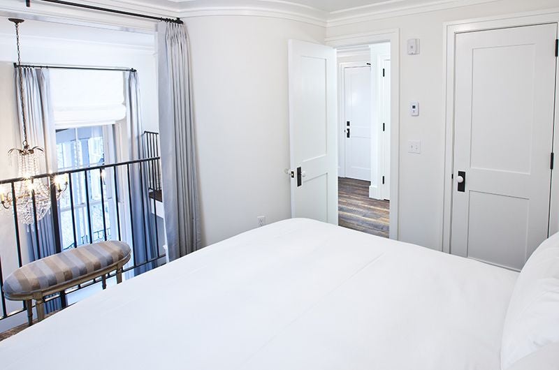 Luxurious lofted one-bedroom suite at [Hotel Name], featuring elegant design, high ceilings, and sophisticated urban-chic decor in a historic scenset setting.