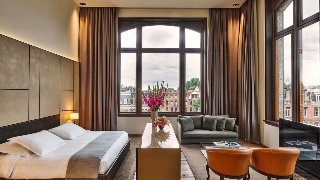 Elegant Van Baerle Suite at Conservatorium Hotel, featuring modern minimalist design with soft neutral tones and expansive city view windows in Amsterdam