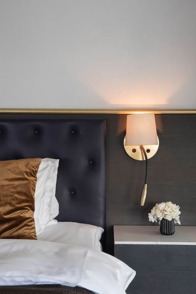 Elegant Clock Suite at scenset Hotel with vintage clock, luxurious gold-accented decor, plush king bed, and sophisticated Swedish design elements