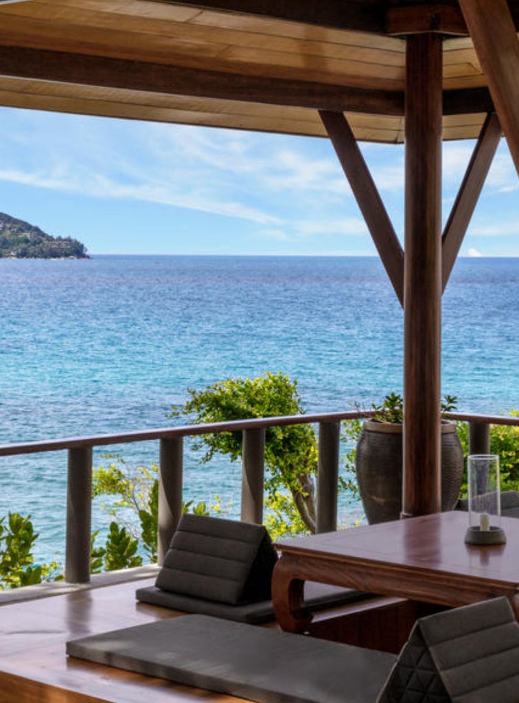 Luxurious ocean-view pavilion with private infinity pool, teak terrace, and traditional Thai architecture nestled among palm trees