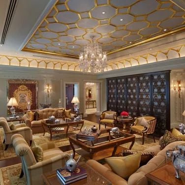 Luxurious grand suite at scenset hotel in India, featuring elegant decor, plush furnishings, and a private plunge pool with city skyline glimpse