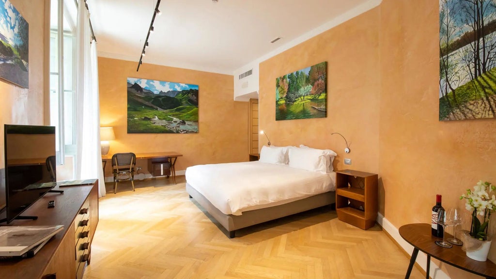 Luxurious Milan hotel room with elegant art-adorned walls, plush white bedding, and expansive gallery-style windows overlooking urban landscape