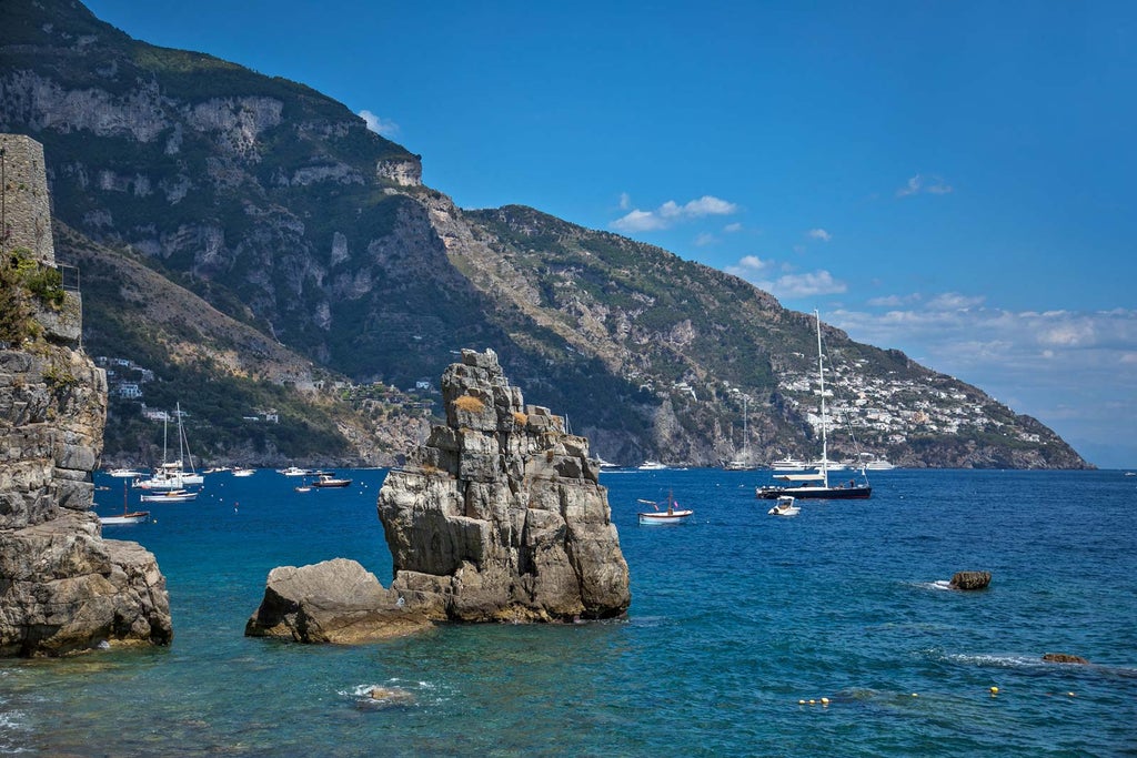 Mediterranean luxury hotel Le Agavi perched on Amalfi Coast cliffs, with cascading terraces, infinity pool overlooking azure sea waters