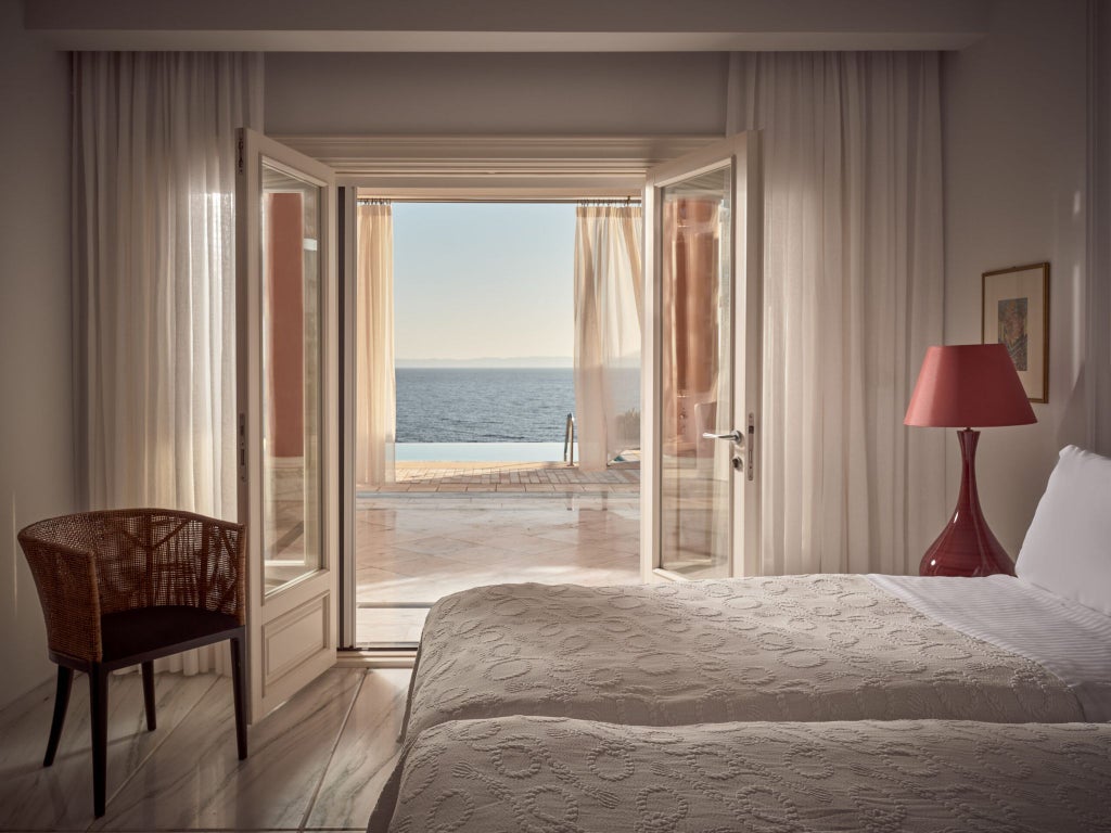 Luxurious Mandarin Villa at beachfront resort, featuring elegant interior with wooden accents, private pool, and panoramic Aegean Sea view in Greece