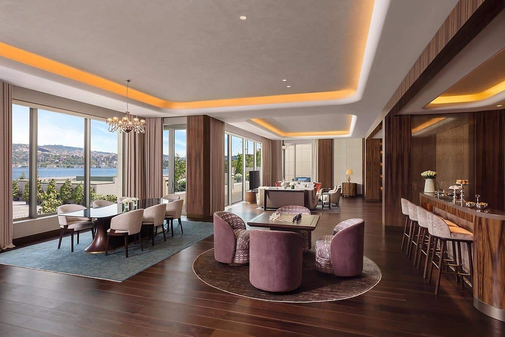 Luxurious suite with panoramic Bosphorus views, elegant contemporary design, plush king bed, and floor-to-ceiling windows overlooking Istanbul's iconic waterway.