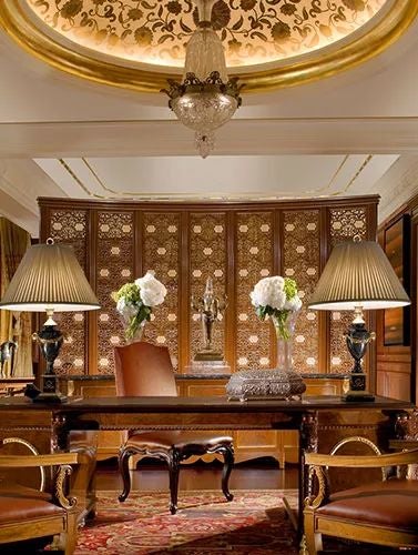 Opulent royal suite at scenset Palace New Delhi featuring expansive living space, elegant furnishings, and private plunge pool with cityscape views through floor-to-ceiling windows