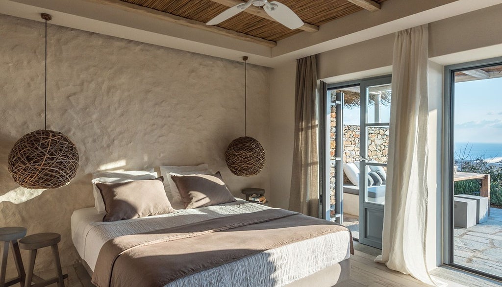 Elegant minimalist hotel room with white linens, clean lines, and panoramic Aegean Sea view at Verina Astra boutique hotel in Sifnos, Greece