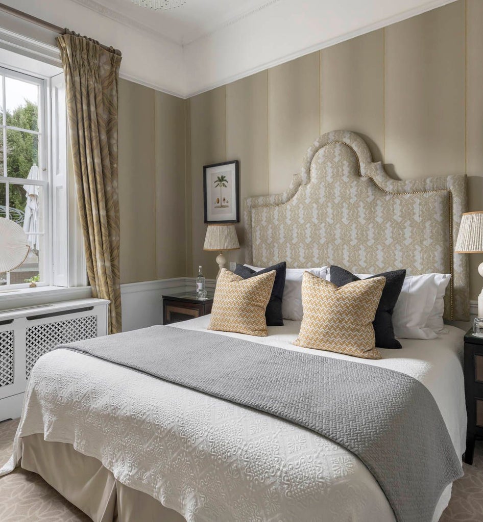 Elegant garden villa at The Royal Crescent Hotel & Spa, featuring plush furnishings, soft neutral tones, and expansive windows overlooking manicured gardens in Bath, United Kingdom.