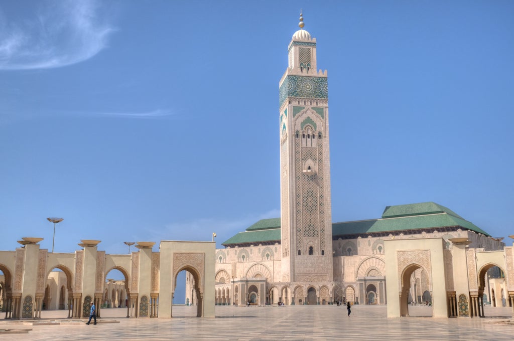 Luxurious riad courtyard in Casablanca with ornate Moroccan archways, traditional zellige tiles and a tranquil fountain pool