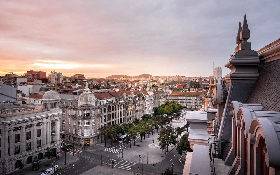 Luxurious Art Deco facade of historic hotel in Porto, featuring elegant golden details, grand windows, and ornate architectural elements of early 20th-century design.