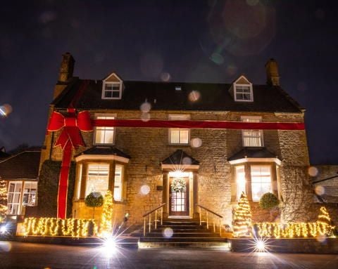 Elegant studio suite at Dormy House Hotel & Spa with plush bed, contemporary furnishings, neutral color palette, and soft natural lighting from expansive windows