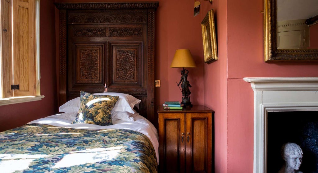 Elegant club single room at Hazlitt's with antique furniture, plush bedding, hardwood floors, and classic British architectural details in warm tones