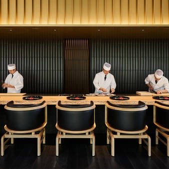 Traditional Japanese ryokan-style hotel with minimalist design, nestled among lush green forest, featuring zen gardens and tranquil pavilions