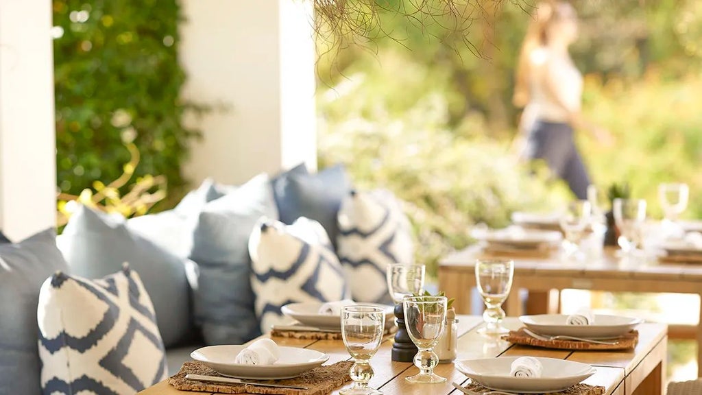 Whitewashed luxury boutique hotel with terracotta roofs nestled in Algarve landscape, featuring minimalist design and traditional Portuguese architectural elements