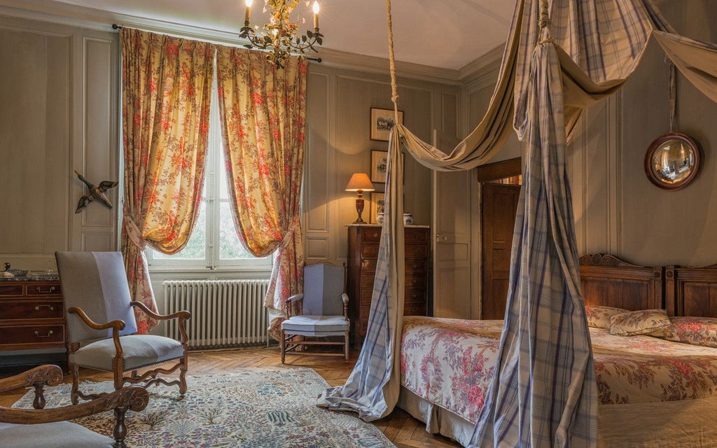 Elegant French hotel room with antique furnishings, soft blue walls, ornate wooden bed, and traditional duck-themed decor in Saint Paterne, Normandy