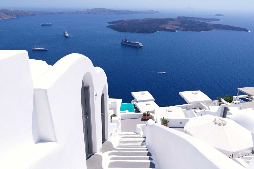 Luxurious white-washed hotel suites with infinity pools cascading down Santorini's cliffside, overlooking the stunning azure Aegean Sea at sunset