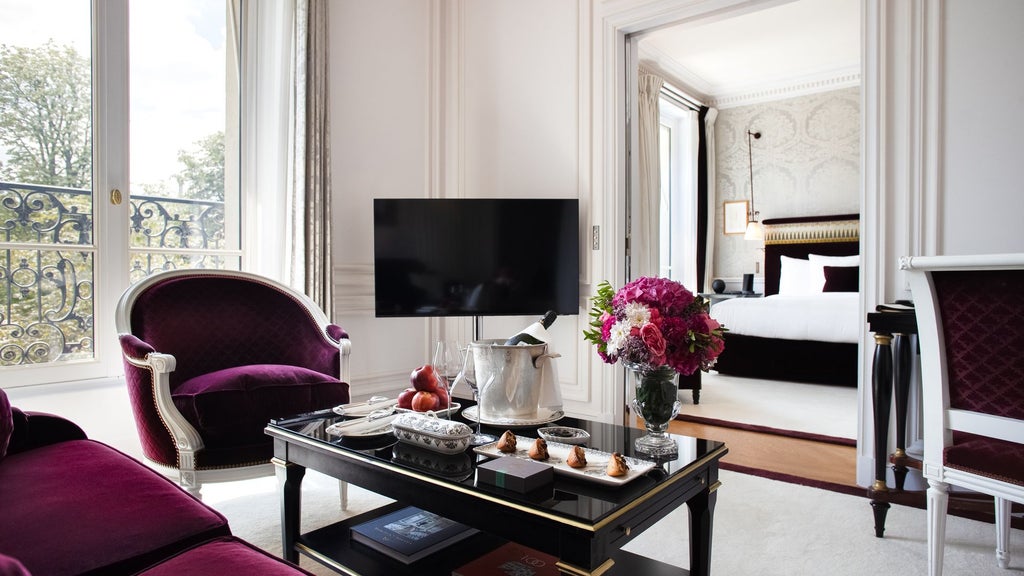 Elegant Parisian deluxe suite with plush cream furnishings, marble accents, floor-to-ceiling windows overlooking cityscape at refined hotel