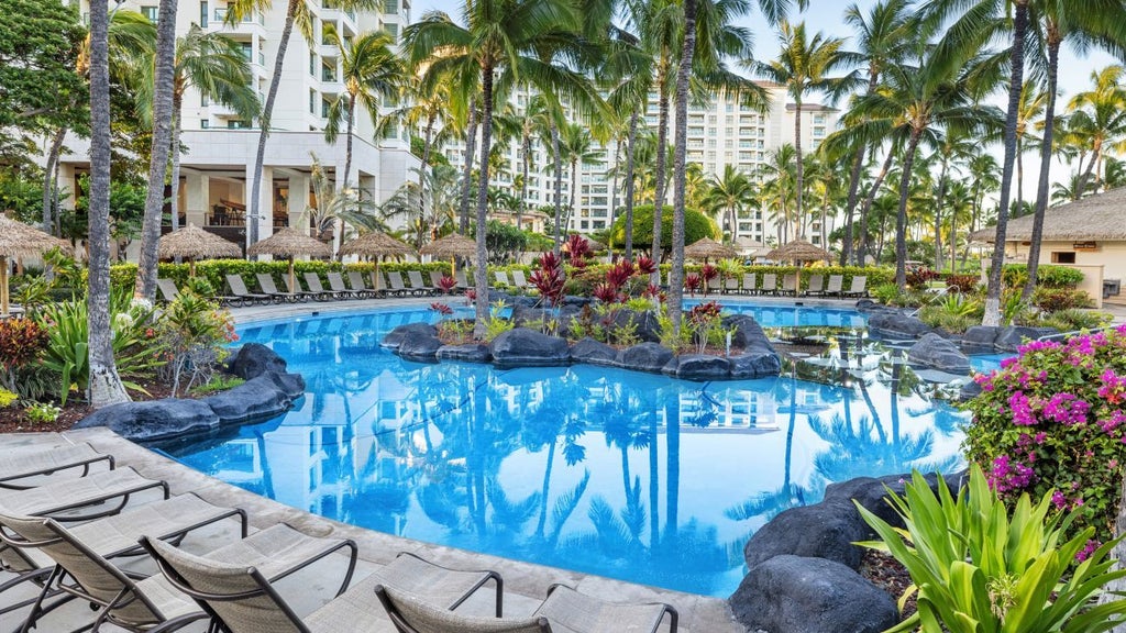 Luxurious beachfront resort with palm trees, azure waters, and modern Hawaiian-style architecture at Scenset's Ko Olina Beach Club in tropical paradise