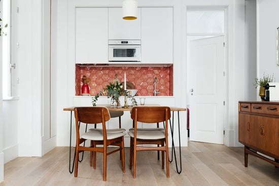 Modern, spacious one-bedroom apartment in Lisbon with elegant neutral decor, wood floors, floor-to-ceiling windows, and minimalist contemporary furnishings