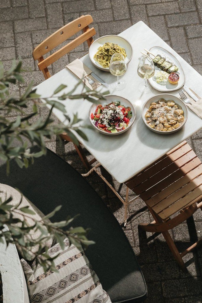 Minimalist rooftop terrace of luxurious boutique hotel in Athens, Greece, with modern furniture and Acropolis views at golden hour