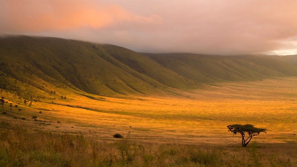 Luxury tented camp perched on Ngorongoro Crater rim, showcasing panoramic Tanzanian landscape with elegant canvas tent and dramatic African wilderness