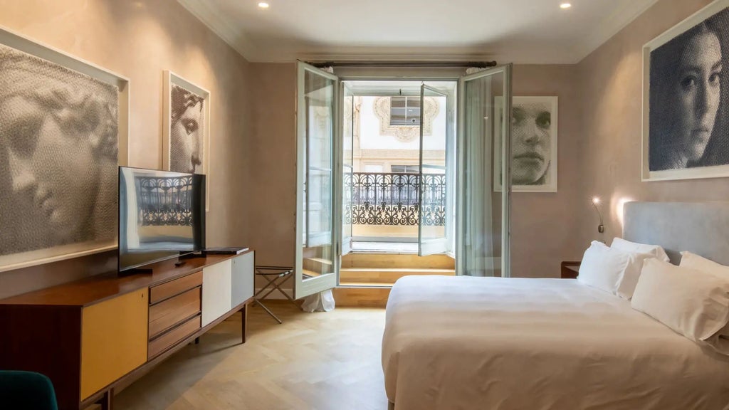 Elegant Italian hotel room with high ceilings, ornate artwork, luxurious white bed, and classic architectural details in warm neutral tones