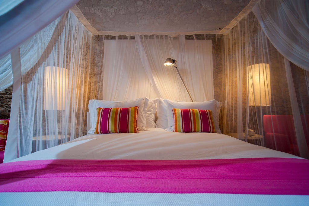 Elegant Brazilian boutique hotel suite with soft pink decor, plush white bedding, and turquoise accents in a minimalist, luxurious design setting