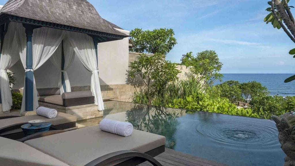 Luxurious oceanfront villa with infinity pool, private terrace, modern Balinese decor, and panoramic views of the Indian Ocean