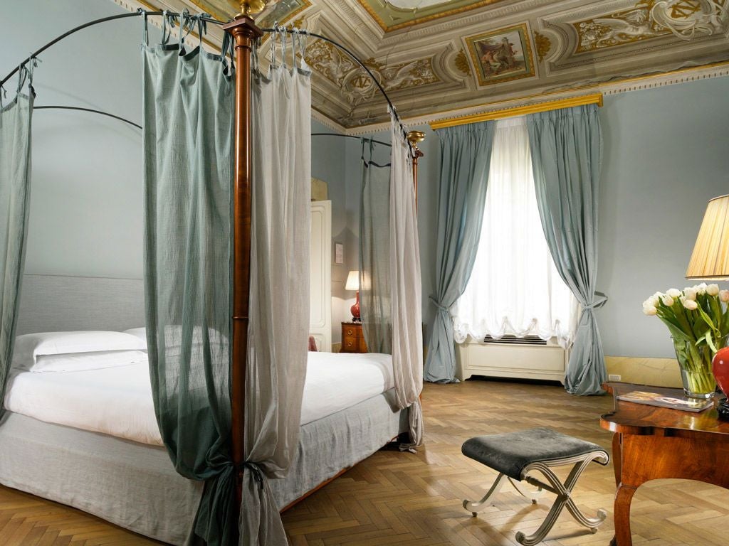 Elegant Renaissance palazzo in Tuscany with ornate frescoed interiors, crystal chandeliers, and antique furnishings showcasing Italian nobility's luxurious historic residence