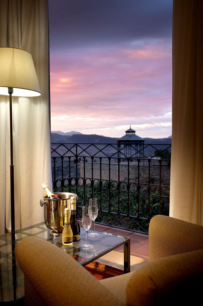 Spanish luxury hotel El Parador features whitewashed walls, grand stone archways, terracotta roof tiles and lush Mediterranean gardens