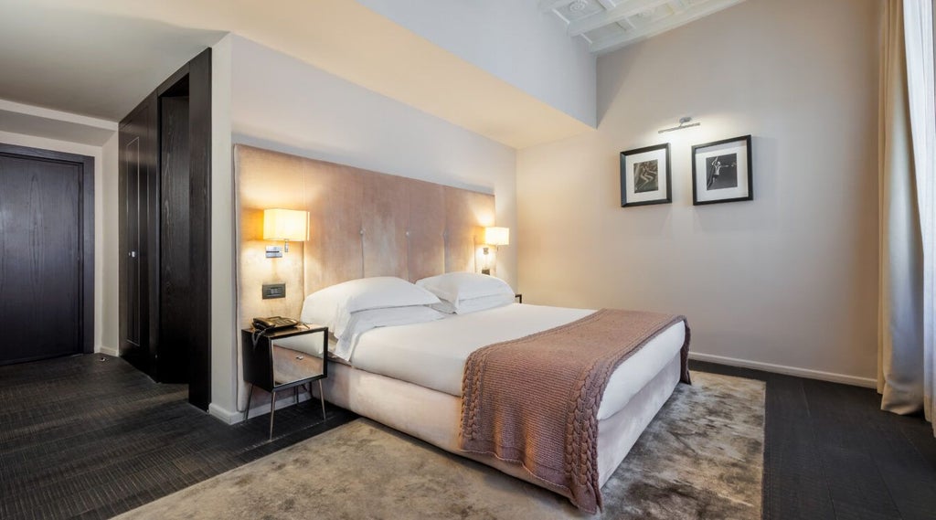 Elegant deluxe hotel room with sophisticated Italian design, premium neutral color palette, luxurious bedding, and refined minimalist decor in a historic Roman setting