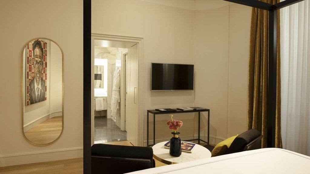 Elegant deluxe hotel room with modern Italian design, soft neutral tones, luxurious spa-like bathroom, and panoramic city view in Rome's historic center