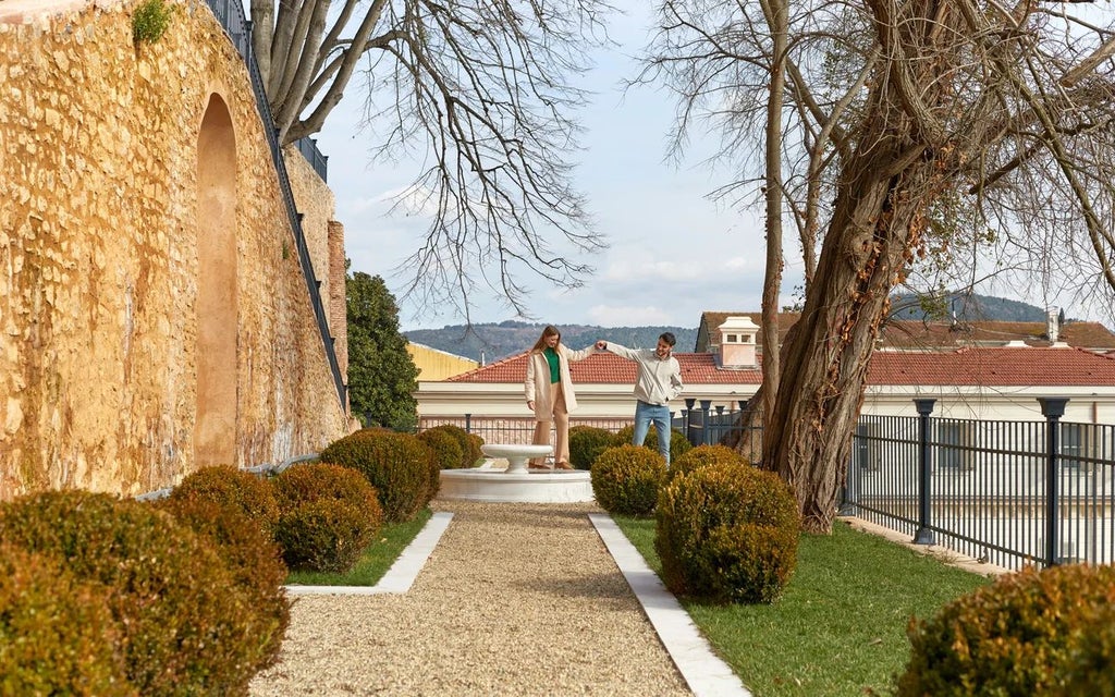 Luxurious historic Ottoman mansion with elegant terrace, intricate architectural details, and lush green garden in Istanbul, showcasing Six Scenset boutique hotel charm