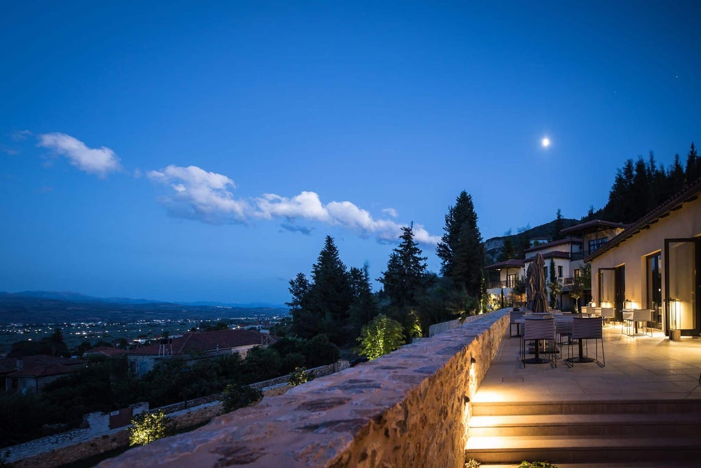 Minimalist luxury spa resort nestled in Greek hillside with infinity pool overlooking misty mountain valleys and cypress trees