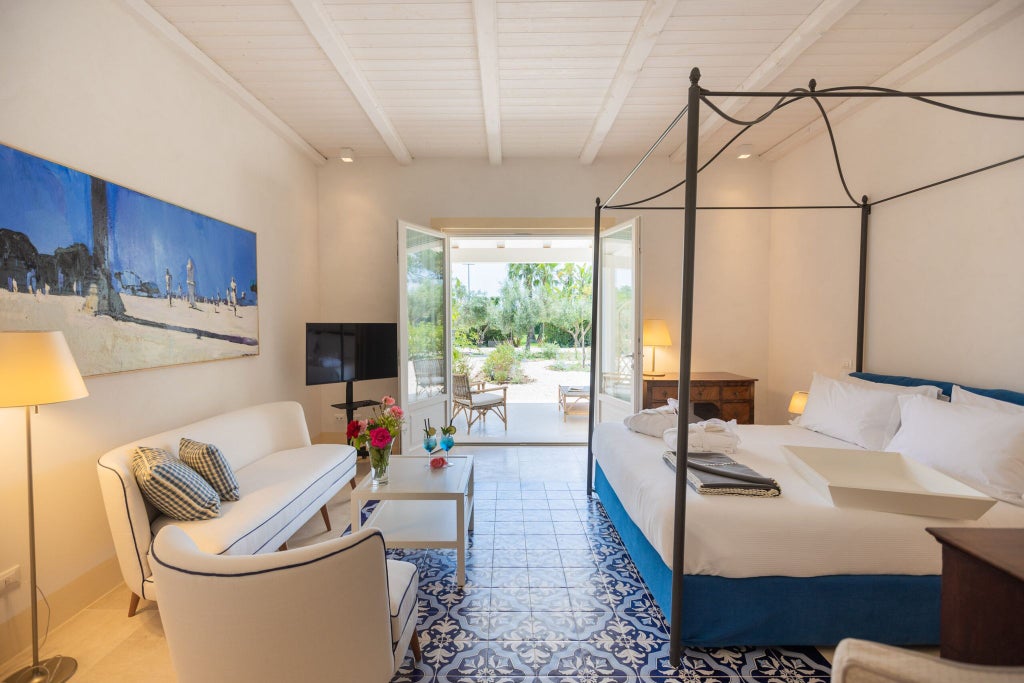 Elegant Sicilian hotel room with luxurious cream-colored linens, antique wooden furniture, and soft natural light filtering through traditional Italian windows