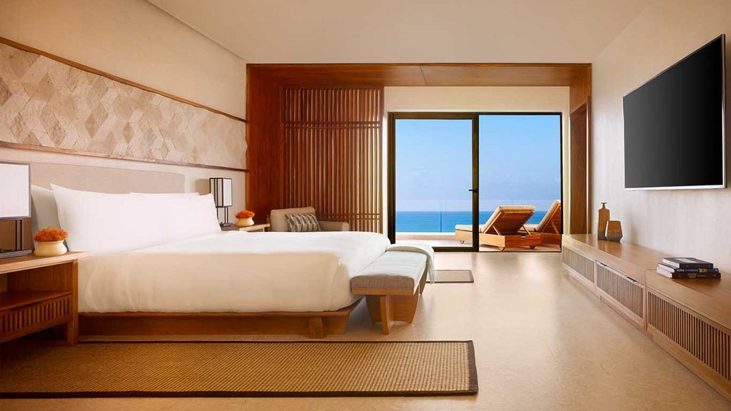 Spacious luxury suite with panoramic ocean views, modern Japanese-inspired decor, floor-to-ceiling windows, and private terrace seating.