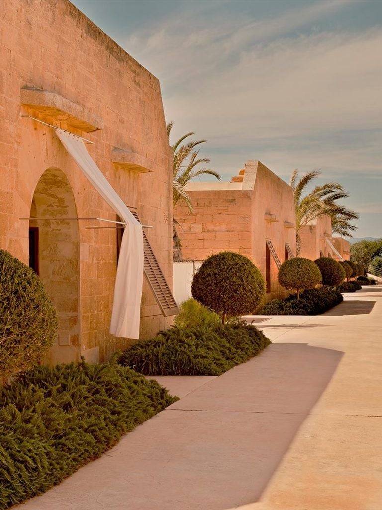 Elegant stone fortress hotel Cap Rocat perched on Mallorca cliffs, featuring Mediterranean Sea views and historic military architecture