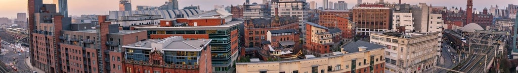 Boutique luxury hotel with urban brick exterior, nestled in historic Manchester, showcasing contemporary architectural design with elegant terracotta-toned facade