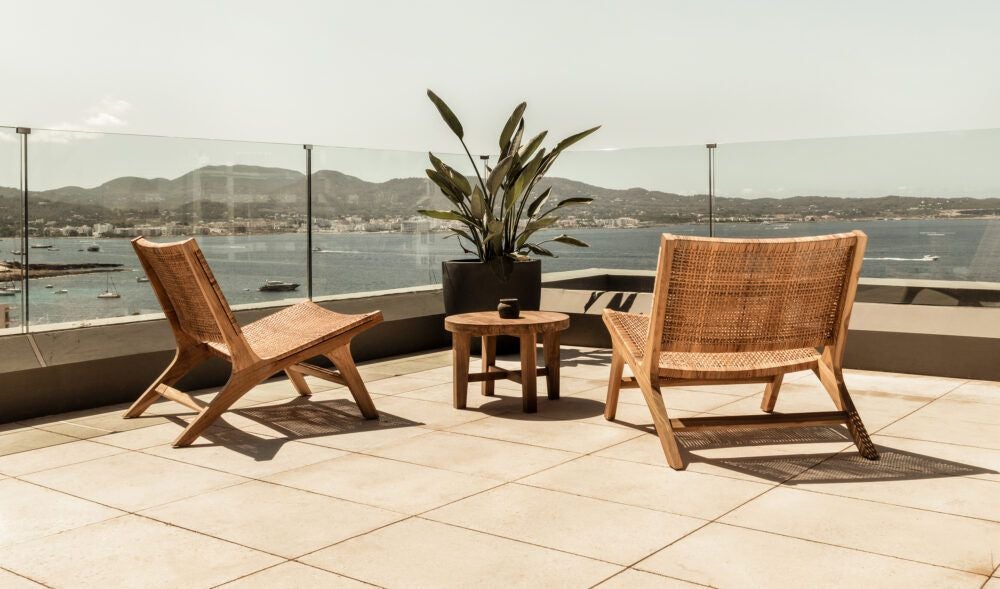 Luxurious white-themed rooftop hotel room at OKU Ibiza with minimalist design, crisp linens, and panoramic views of Mediterranean landscape