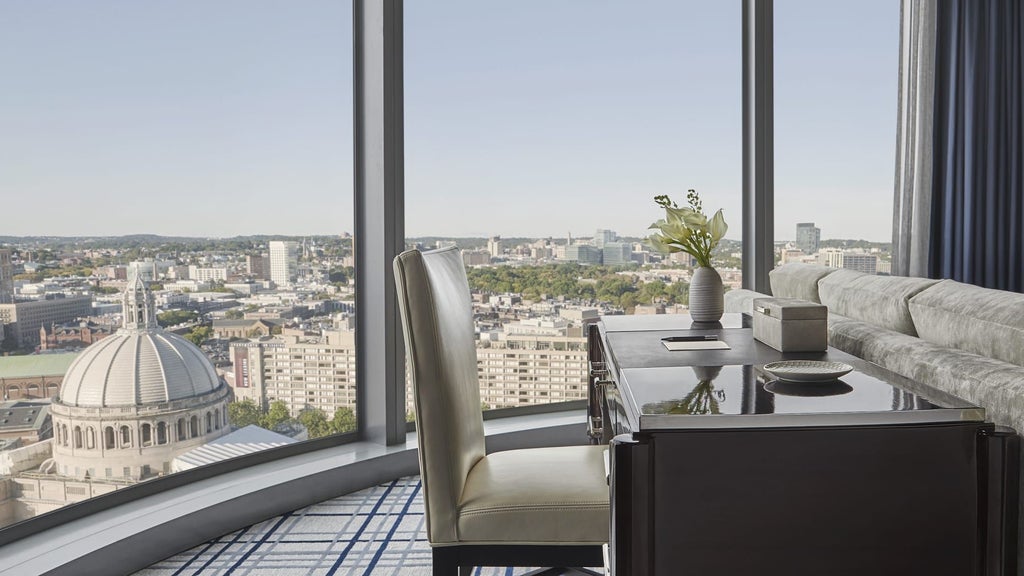 Lavish presidential suite with panoramic city views, elegant cream and gold decor, king-sized bed, modern marble bathroom at scenset Hotel in Boston