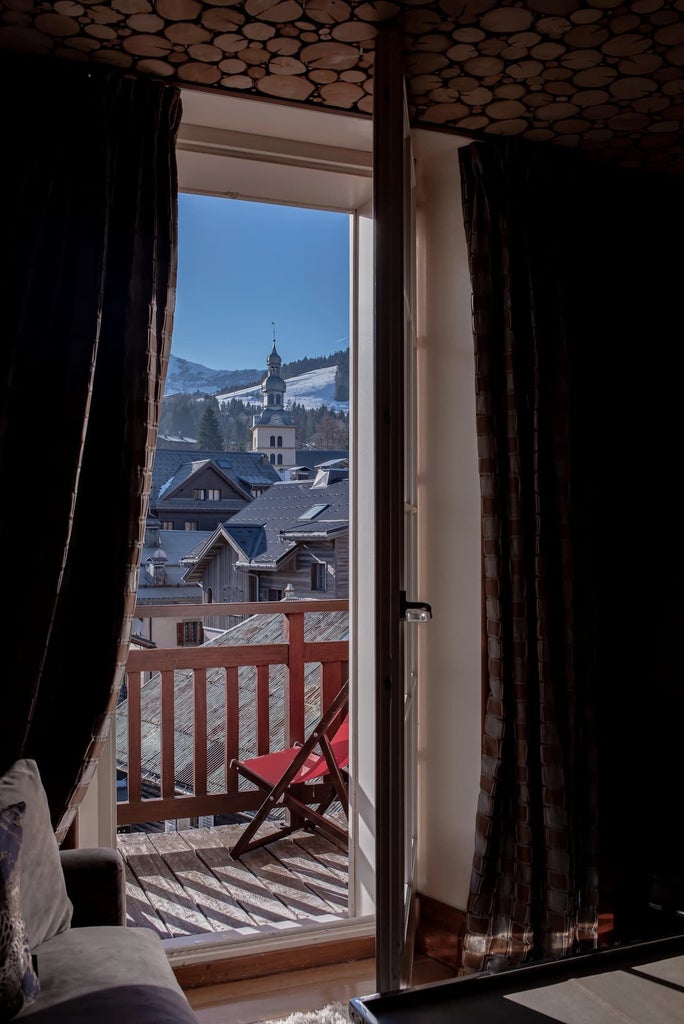 Elegant French mountain lodge with stone exterior, warm wood accents, and snow-capped alpine landscape, exuding rustic luxury and alpine charm.