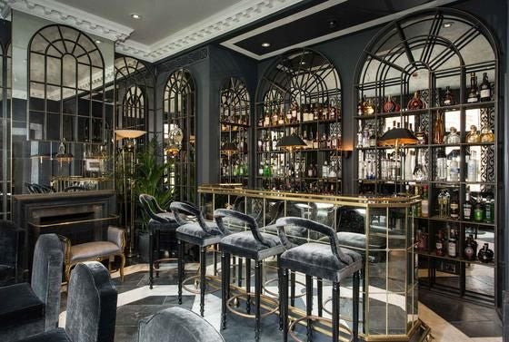 Elegant exterior of luxury boutique hotel with classic British architecture, illuminated windows, and sophisticated urban facade in central London setting