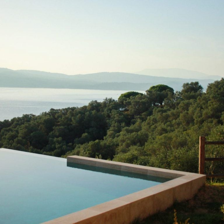 Luxurious junior suite with private pool overlooking azure waters, featuring modern design and sleek Mediterranean-inspired interior at ELIVI Skiathos resort in Greece.