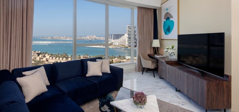 Spacious two-bedroom sea view apartment with modern decor, floor-to-ceiling windows, and luxurious furnishings in Scenset Dubai hotel suite